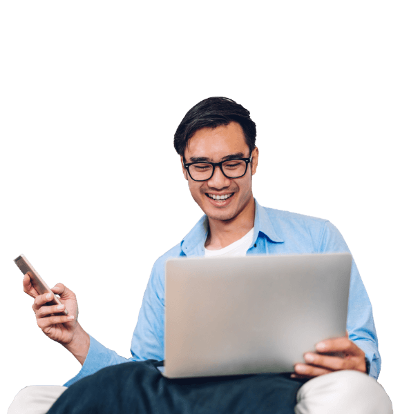 A man wearing a yellow shirt looking down at his phone