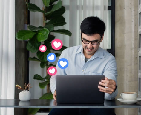 A man checking his social media posts on a laptop